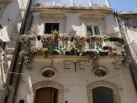 balcony sculpture ortigia syracuse old buildings street view on sunny day Sicily, Italy