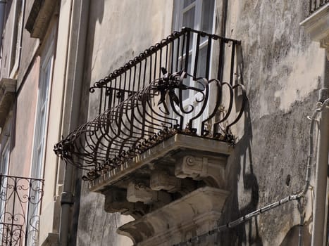 balcony sculpture ortigia syracuse old buildings street view on sunny day Sicily, Italy