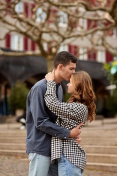 Young Cute Female Hugs Boyfriend. In Autumn Outdoor. Lovers Walking in Park. Attractive Funny Couple. Lovestory in Forest. Man and Woman. Cute Lovers in the Park. Family Concept. Happy Couple.