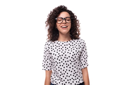 young caucasian woman with curly hair styling dressed in a summer blouse with short sleeves.