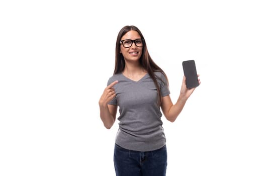 portrait of a pensive caucasian slim young woman in glasses showing smartphone screen.
