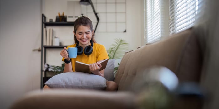 Happy young woman read book on sofa at home. Lifestyle freelance relax in living room. lifestyle relaxation concept.