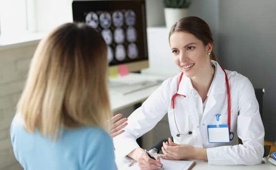 Woman sitting at appointment of gynecologist in clinic. Outpatient medical care concept