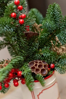 Homemade christmas decorations on table. Christmas bouquet in vase