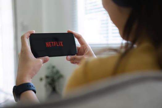 CHIANG MAI, THAILAND DEC 15, 2023: Netflix logo on iPhone 14 screen. Netflix is an international leading subscription service for watching TV episodes and movies.