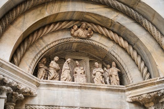 The exterior of the Cathedral in Como city, with Italian architectural details, sculpture, stone carvings. Lombardy. Italy
