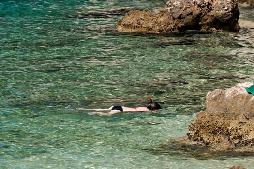 Snorkelist in crystal clear water of Adriatic sea in Brela on Makarska Riviera, Dalmatia Croatia