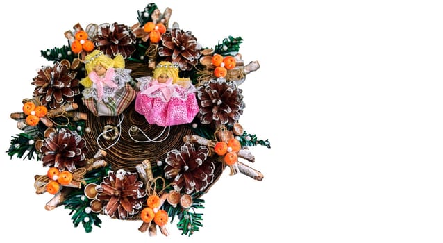 Christmas wreath with pine cones, toys on a white background. With angels in the middle.
