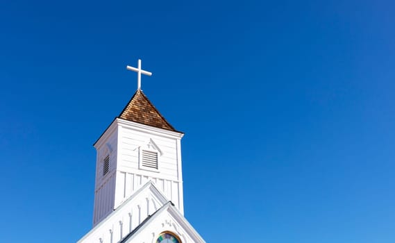 Wooden Church Steeple with Cross. White Old Church, Blue Sky On Background. Copy Space For Text. Christian Religious Holiday Easter or Radonitsa. Horizontal Plane Horizontal Plane High quality photo