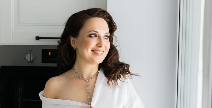 Close-up woman wears massive chain on neck, metal necklace. Modern jewellery