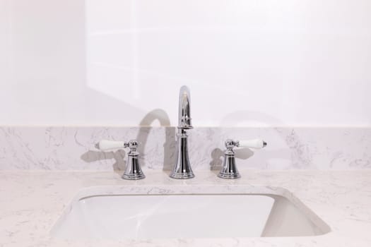 White Gray Square Granite Sink And Silver Faucet in Bathroom, White Walls. Copy Space for Text. Horizontal Plane. Bathroom Vanity. Home Decor and Design. High quality photo