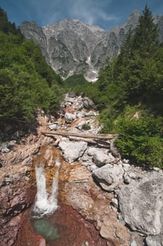 Waterfall on red rock in the Leoganger Steinberge, near Leogang in Austria