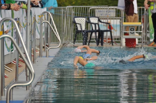 Athletes swimming in the pool during a triathlon competition in Germany