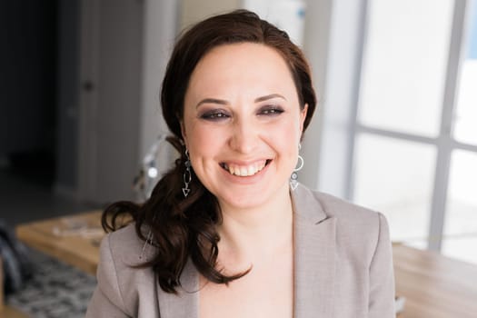 Portrait of a female online store business owner looking away and smiling. Woman doing her small business from home