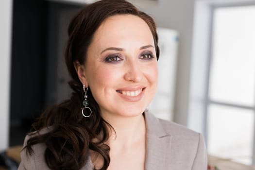 Portrait of a female online store business owner looking away and smiling. Woman doing her small business from home