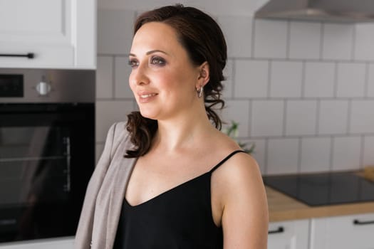 Portrait of a female online store business owner looking away and smiling. Woman doing her small business from home