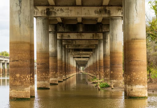 Receding pillars of the I-10 interstate bridge over the bayou of Atchafalaya basin near Baton Rouge Louisiana