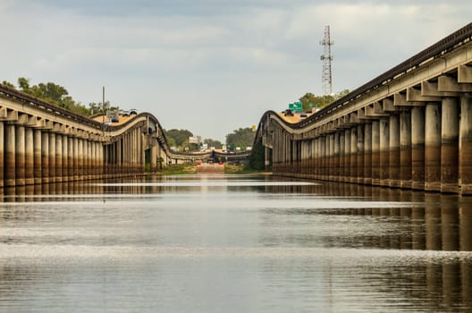 Receding pillars of the I-10 interstate bridges over the bayou of Atchafalaya basin near Baton Rouge Louisiana