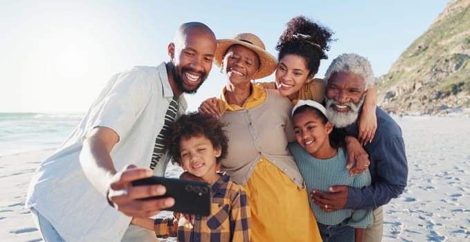 Love, selfie and happy family at a beach for travel, fun or adventure in nature together. Ocean, profile picture and African kids with parents and grandparents at the sea for summer, vacation or trip.