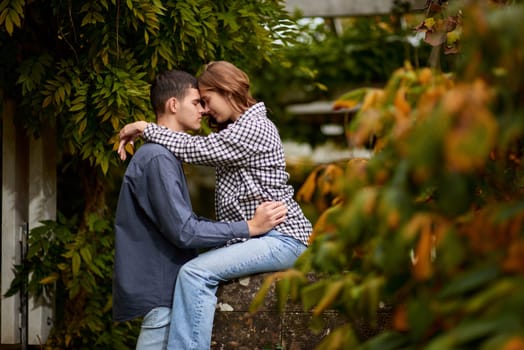 Joyful Autumn Embrace: Cute Lovers Strolling in the Park. Young Cute Female Hugs Boyfriend. In Autumn Outdoor. Lovers Walking in Park. Attractive Funny Couple. Lovestory in Forest. Man and Woman. Cute Lovers in the Park. Family Concept. Happy Couple.