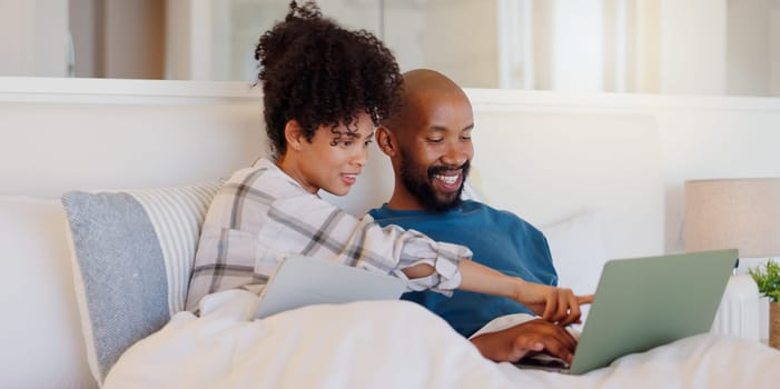 Home, bed or black couple with technology, relax or smile with love, internet or streaming a movie. Bedroom, apartment or man with woman, connection or film with website for comedy, laptop or bonding.
