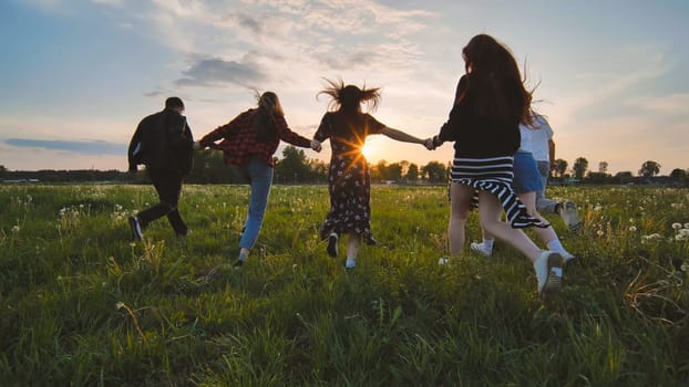 Merry friends run off into the sunset holding hands