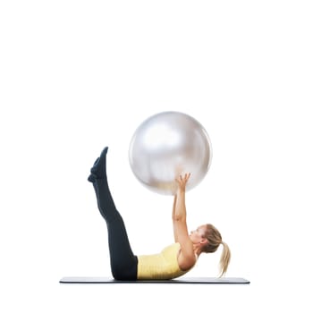 Yoga ball, sports and woman in studio with body, health and wellness exercise for balance. Fitness, equipment and young female athlete with stretching workout or training isolated by white background.