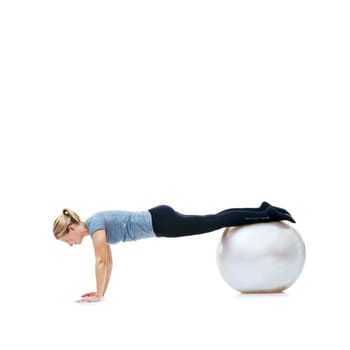 Yoga ball, fitness and woman in studio with body, health and wellness exercise for balance. Sports, equipment and young female athlete with stretching workout or training isolated by white background.