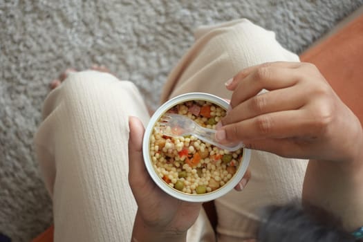 women eating canned bulgur rice .