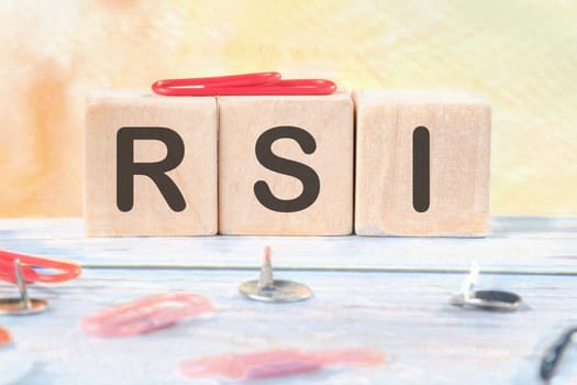 RSI Relative Strength Index signs on wooden cubes on a light background