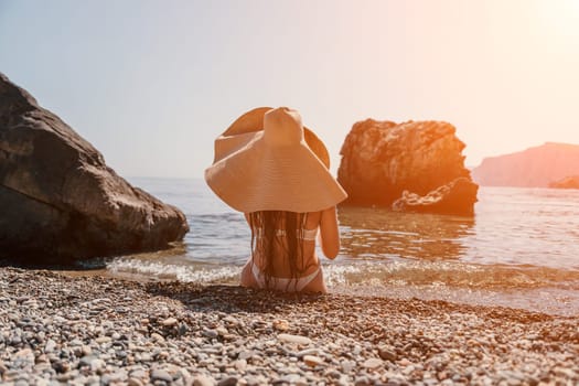 Woman travel sea. Happy tourist taking picture outdoors for memories. Woman traveler looks at the edge of the cliff on the sea bay of mountains, sharing travel adventure journey.