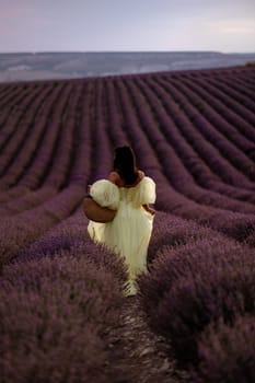 Woman lavender field. Lavender field happy woman in yellow dress in lavender field summer time. Aromatherapy concept, lavender oil, photo session in lavender.