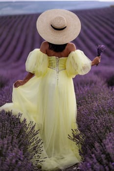 Woman lavender field. Lavender field happy woman in yellow dress in lavender field summer time. Aromatherapy concept, lavender oil, photo session in lavender.