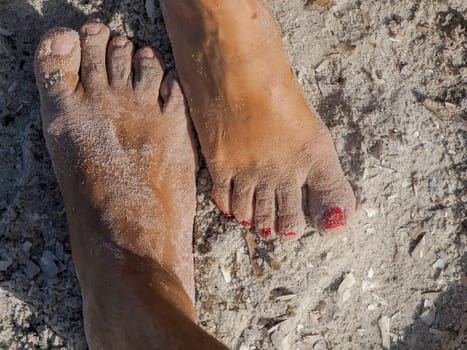 man and woman together human foot on sand in silver beach in porquerolles island france, panorama landscape