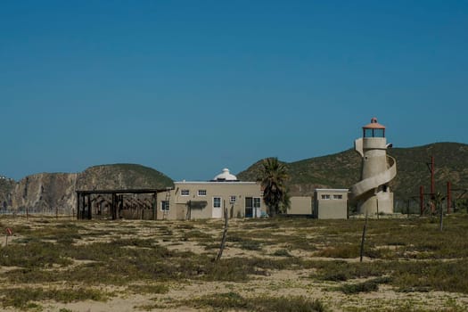 An Abandoned lighthouse in Pacific Ocean beach of baja california sur landscape from boat