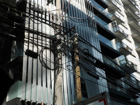 Mexico City, Messed up power lines and connection cables. Many tangled wires on electric poles in the city