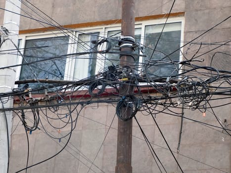 Mexico City, Messed up power lines and connection cables. Many tangled wires on electric poles in the city