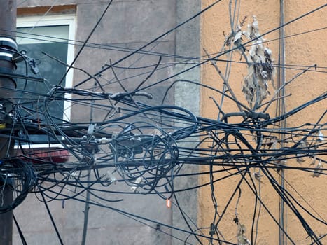 Mexico City, Messed up power lines and connection cables. Many tangled wires on electric poles in the city