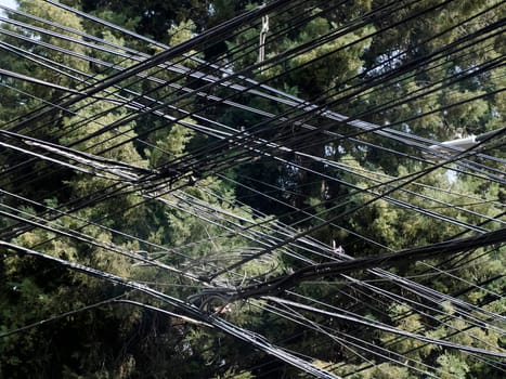 Mexico City, Messed up power lines and connection cables. Many tangled wires on electric poles in the city