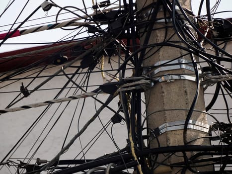 Mexico City, Messed up power lines and connection cables. Many tangled wires on electric poles in the city