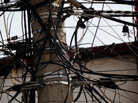 Mexico City, Messed up power lines and connection cables. Many tangled wires on electric poles in the city