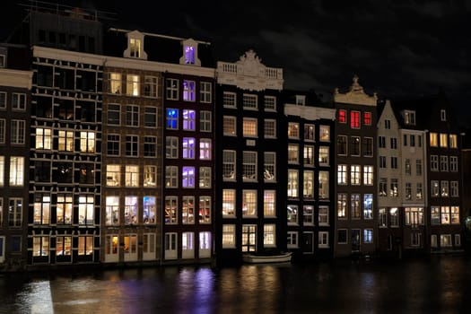 amsterdam ancient buildings over canals, netherlands night view