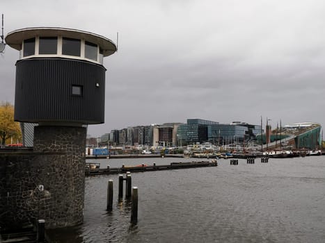 amsterdam: maritime museum and cityscape on rainy day