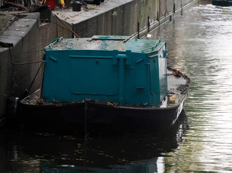 Boat on canals of Amsterdam view on rainy day Netherlands