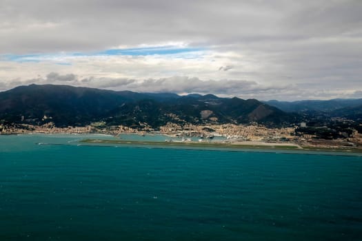 Airport of Genoa Italy aerial view before landing to airport by airplane during a sea storm tempest hurricane