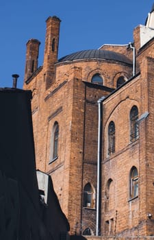 Old church - historic building from red bricks, back side photo. Street architecture, Kharkiv, Ukraine. High quality picture for wallpaper, travel blog.