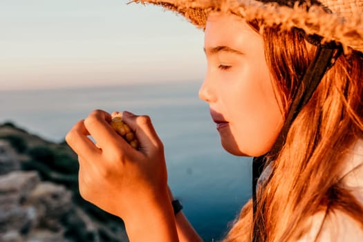 Portrait of young beautiful girl eating corn. Snacking on the sea