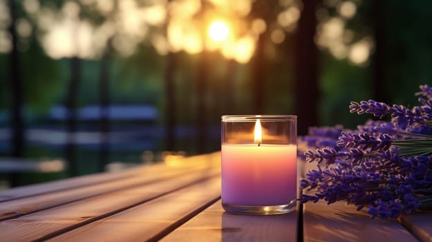 A burning candle and lilac flowers against the background of a garden. Banner with copy space. Self care and aromatherapy concept. High quality photo