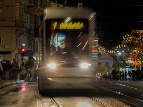 A Night moving Trolley tram in graz austria tracks and cables in winter season