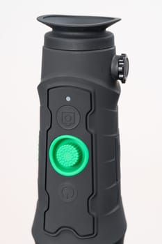 Long-range monocular isolated on white background, rubber body with large green on off button.